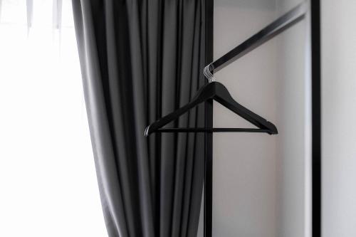 a black curtain hanging in front of a window at CREW Hotel in Chiang Mai