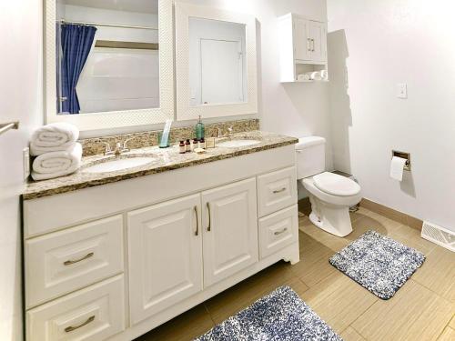 a white bathroom with a sink and a toilet at Blue House in Sioux Falls