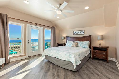 a bedroom with a bed with a view of the ocean at Grotto on the Gulf in Fort Morgan