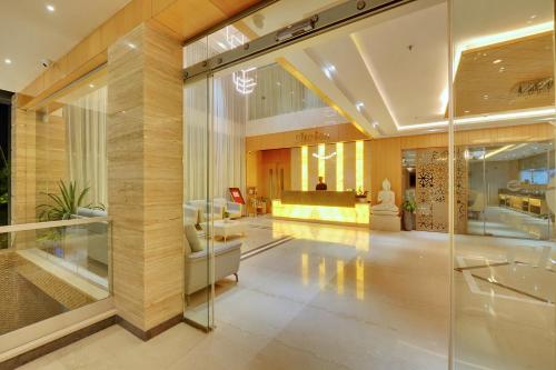 a lobby of a building with glass walls at Clarion Hotel Bangalore in Bangalore