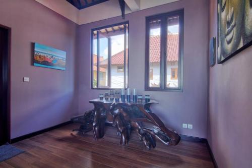 a room with a table and some windows at Uluwatu Huge 6 Bed Spa Villa - G8 views & Child Friendly in Jimbaran