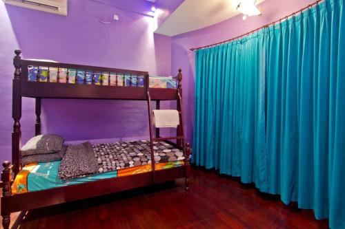 a bedroom with two bunk beds and purple walls at Uluwatu Huge 6 Bed Spa Villa - G8 views & Child Friendly in Jimbaran