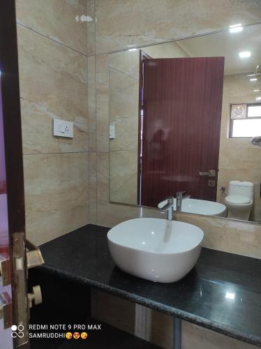 a bathroom with a sink and a mirror at Hotel Calangute Central in Calangute
