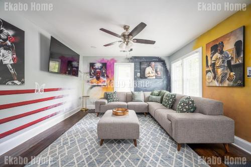 a living room with a couch and a ceiling fan at Luxury Sports Art Gallery - 15 mins to ATL Battery in Marietta