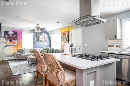 a kitchen with a kitchen island with a stove at Luxury Sports Art Gallery - 15 mins to ATL Battery in Marietta