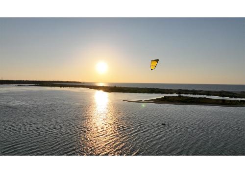 a kite flying over a body of water at The Blue Lagoon Resort Kalpitiya in Kalpitiya
