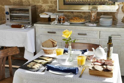 a table with food and bread and drinks on it at El Racó de Madremanya - Adults only in Madremanya