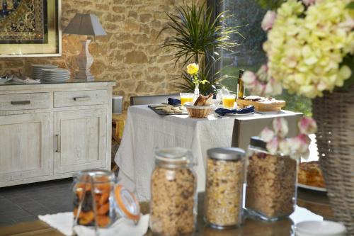 a table with food and jars of food on it at El Racó de Madremanya - Adults only in Madremanya