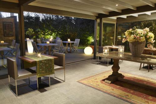a patio with tables and chairs and a table with flowers at El Racó de Madremanya - Adults only in Madremanya