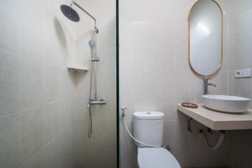a bathroom with a toilet and a sink and a shower at [Seminyak central] private 3 bedrooms villa with swimming pool in Seminyak