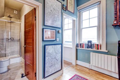 a bathroom with a door with a map on the wall at Sunny Corner Apartment in Center of London in London