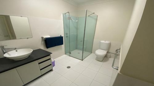a bathroom with a glass shower and a toilet at Unit 66 Seafront Estate in Jurien Bay