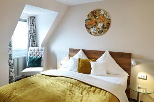 a bedroom with a large bed with a yellow blanket at Hotel Vorderburg in Schlitz