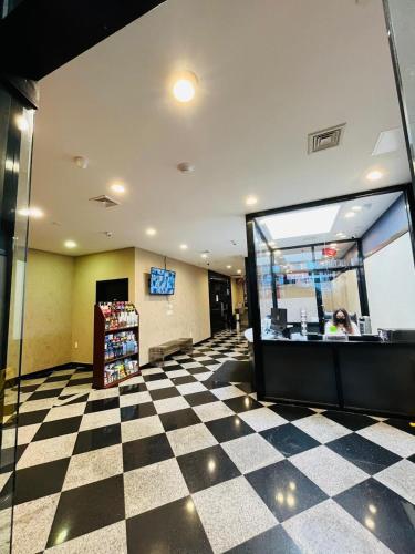 a store lobby with a checkered floor at Hotel Key in Queens