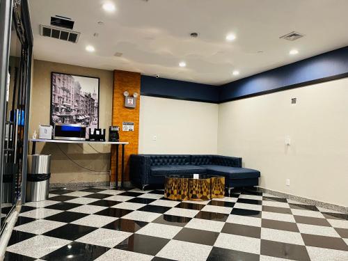 a lobby with a couch and a checkered floor at Hotel Key in Queens