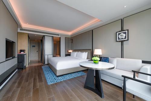 a hotel room with a bed and a table at Empark Grand Hotel Beijing in Beijing