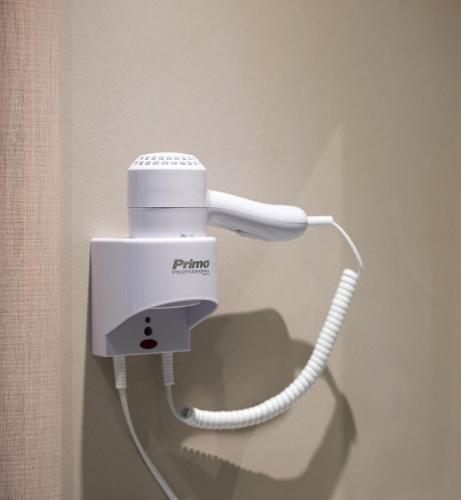 a white phone is hanging on a wall at Light Blue Hotel in Nea Kalikratia
