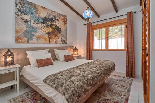 - une chambre avec un grand lit et une fenêtre dans l'établissement La Montaña Del Oro, à Sayalonga