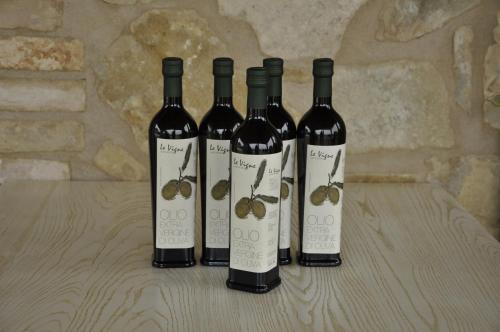three bottles of wine sitting on a table at Agriturismo Le Vigne in Foligno