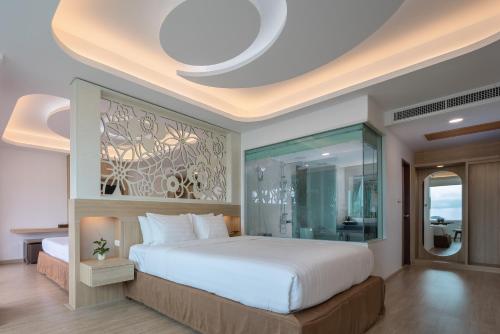 a bedroom with a large bed and a glass wall at Chaba Cabana Beach Resort in Chaweng