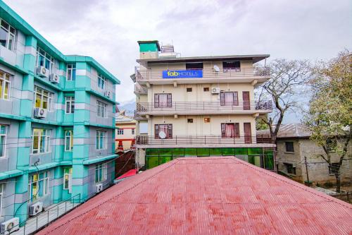 a building on top of a red roof at Hotel City Plaza in Dharamshala