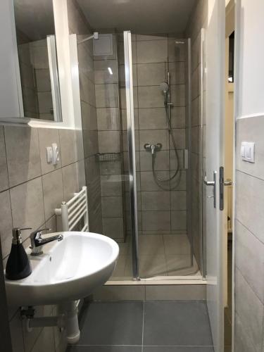 a bathroom with a shower and a sink at Penzión Radlinka in Prešov