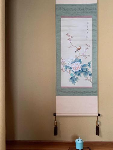 a wall with a picture of flowers on it at unsui 武雄蓬莱町 雲水 in Takeo