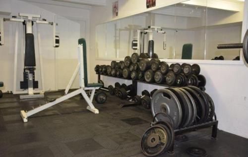 a room with a bunch of dumbbells in a gym at Hotel O.K. 1 in Beroun
