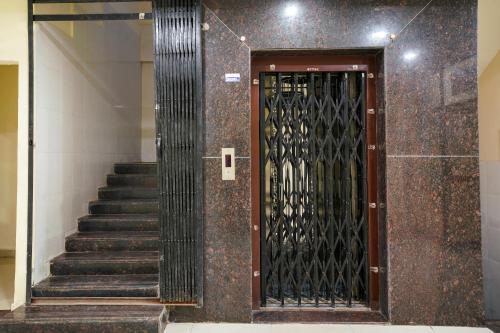 a door in a building with a staircase and a stair case at 69076 OYO Hotel Sweekar in Shamshabad
