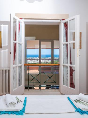 a bedroom with a view of the ocean seen through doors at Villa Verde in Malia