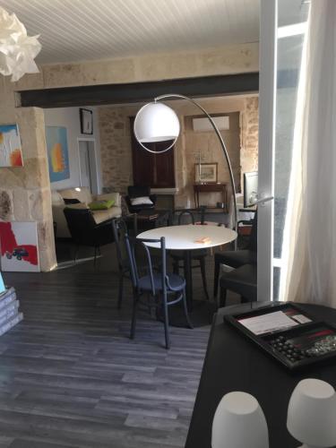 une chambre avec une table et des chaises ainsi qu'un salon dans l'établissement es aqui, à Souvignargues