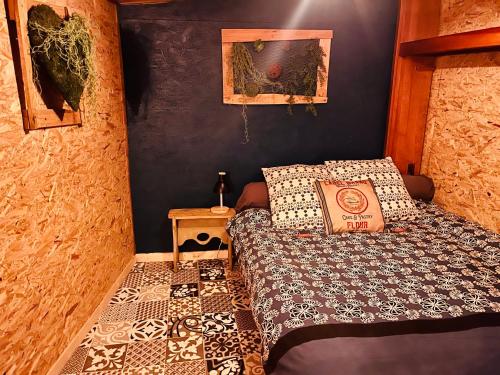 a small bedroom with a bed and a table at Spa La k abane in Blandin