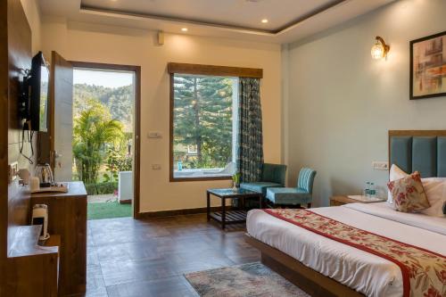 a hotel room with a bed and a window at Dee Fellows Riverside Resort in Garjia