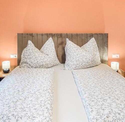 a bedroom with two beds with white sheets and pillows at Hallstatt Lakeside Top 4 - Zimmer mit Balkon in Hallstatt