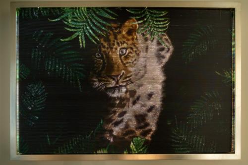 a painting of a tiger on a black background at New San Raffaele Apartment with Free Parking and Air Conditioning in Segrate