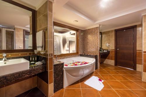 a bathroom with a tub and a sink at Grand Pasha Lefkosa Hotel & Casino in Lefkosa Turk