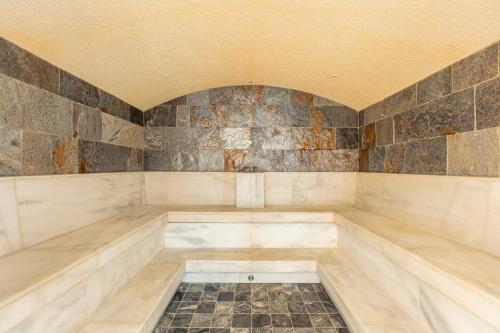 a jacuzzi tub in a room with tiles at Dorfresort Kitzbühel by ALPS RESORTS in Reith bei Kitzbühel
