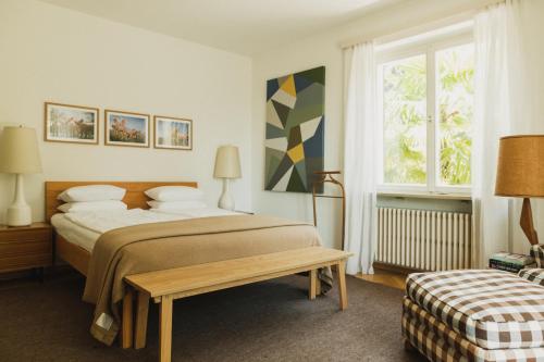 a bedroom with a large bed and a window at Villa Fluggi in Merano