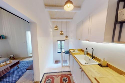 a kitchen with a sink and a counter top at Narrow Street Suite in Victoria