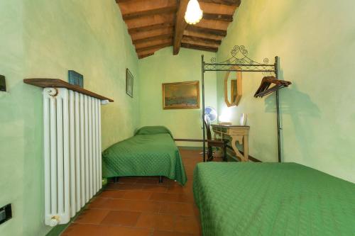 a bedroom with two twin beds and a radiator at Il Mirtillo in Pisa