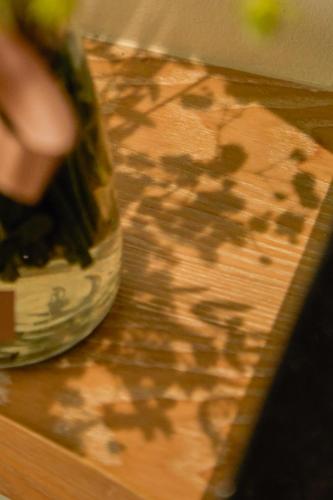 a close up of a vase on a wooden table at Hotel Sapin in Pom Prap