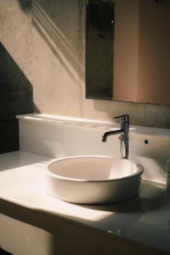 a white sink in a bathroom with a mirror at Bor Saen Pool Villa in Bor Saen
