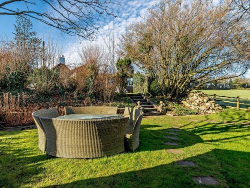 a table and chairs sitting in the grass at Log Cabin near Bath in Chippenham