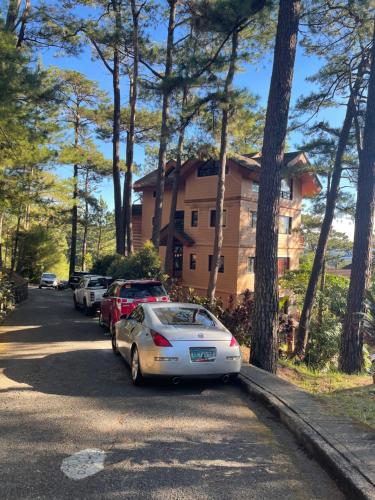 a white car parked in front of a house at 2nd Floor- 3BR camp John Hay Unit For Rent in Baguio