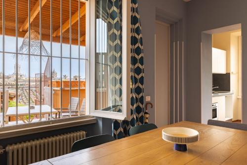 a dining room with a table and a large window at Navona 49 Luxury Suites&Apartment in Rome
