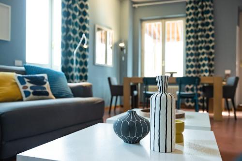 a living room with a couch and a table with vases on it at Navona 49 Luxury Suites&Apartment in Rome