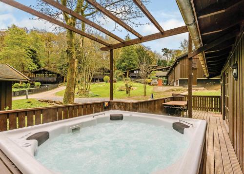 a large hot tub on a wooden deck at Brockwood Hall Lodges in Silecroft