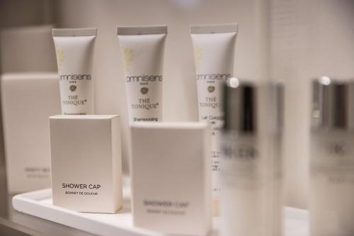 a group of white bottles of sunscreen on a shelf at Navona 49 Luxury Suites&Apartment in Rome