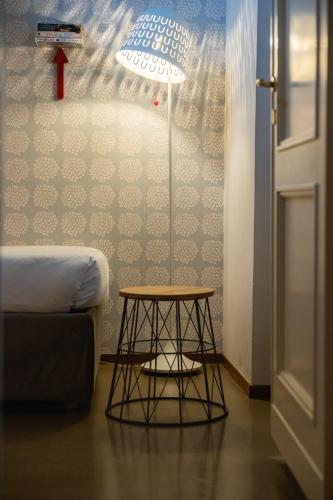 a room with a table and a lamp and a couch at Navona 49 Luxury Suites&Apartment in Rome