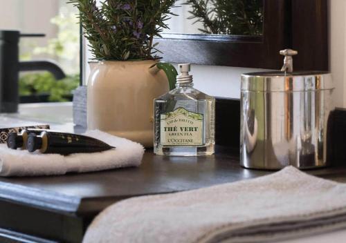 a bathroom counter with a bottle of whiskey and a towel at 17pounds Country Estate & Aqua Wellness Retreat in Bullarto